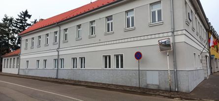 Bílá fasáda dlouhé budovy podél ulice – Malířské práce Martin Šmídek